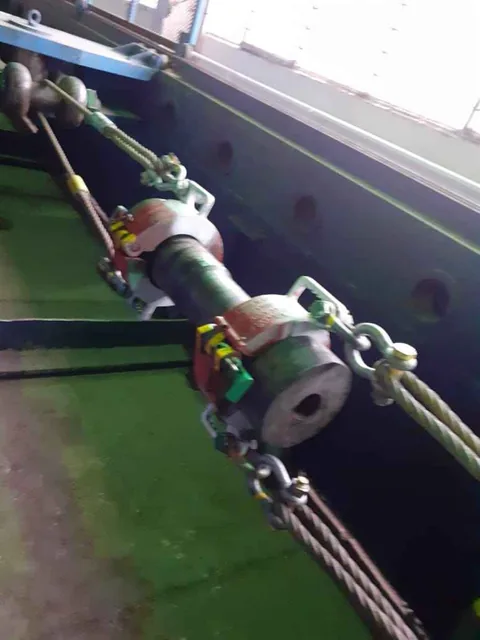 Test specimen connection fixtures inside the tensile test bed load frame
